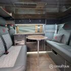 Full interior view of VW T6.1 SWB campervan with shaded cherry flooring, slate grey kitchen, Nolche Marino accents, and pewter upholstery