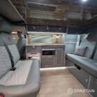 Full interior view of VW T6.1 SWB campervan with shaded cherry flooring, slate grey kitchen, Nolche Marino accents, and pewter upholstery