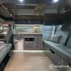 Full interior view of VW T6.1 SWB campervan with shaded cherry flooring, slate grey kitchen, Nolche Marino accents, and pewter upholstery