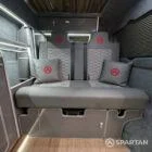 Rock and roll bed finished in pewter upholstery in VW T6.1 SWB campervan