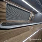 Sink and hob integrated into slate grey kitchen with shaded cherry floor in VW T6.1 SWB campervan