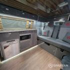 VW T6.1 SWB campervan kitchen interior with shaded cherry flooring, slate grey units and Nolche Marino accents