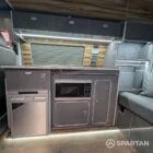Close-up of slate grey kitchen units with Nolche Marino detail in VW T6.1 SWB campervan