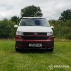 Front view of VW T6.1 Business Pack LWB campervan with pop-top down, Fortana Red and Candy White