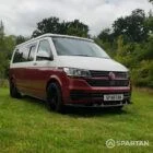 Front driver quarter of VW T6.1 Business Pack LWB campervan with roof down, Fortana Red and Candy White