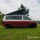Driver side view of VW T6.1 Business Pack LWB campervan with pop-top up, Fortana Red and Candy White