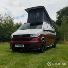 Front passenger quarter of VW T6.1 Business Pack LWB campervan with pop-top up, Fortana Red and Candy White