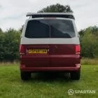 Straight rear view of VW T6.1 Business Pack LWB campervan with pop-top up, Fortana Red and Candy White