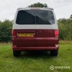 Rear view of VW T6.1 Business Pack LWB campervan with pop-top down, Fortana Red and Candy White
