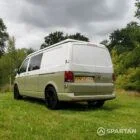 Rear passenger quarter view of VW T6.1 LWB campervan, pop-top roof down, Military Green and Candy White