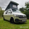 Front view of VW T6.1 LWB campervan with wheels turned, Military Green and Candy White paint