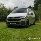 Front passenger quarter of VW T6.1 LWB campervan with roof down, Military Green and Candy White