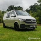 Front driver quarter of VW T6.1 LWB campervan with roof down, Military Green and Candy White