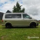 Driver side view of VW T6.1 Highline SWB campervan with pop-top down, Military Green and Candy White