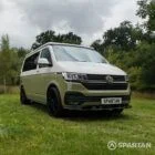Front driver quarter of VW T6.1 Highline SWB campervan with roof down, Military Green and Candy White