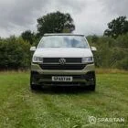 Front view of VW T6.1 Highline SWB campervan with pop-top down, Military Green and Candy White