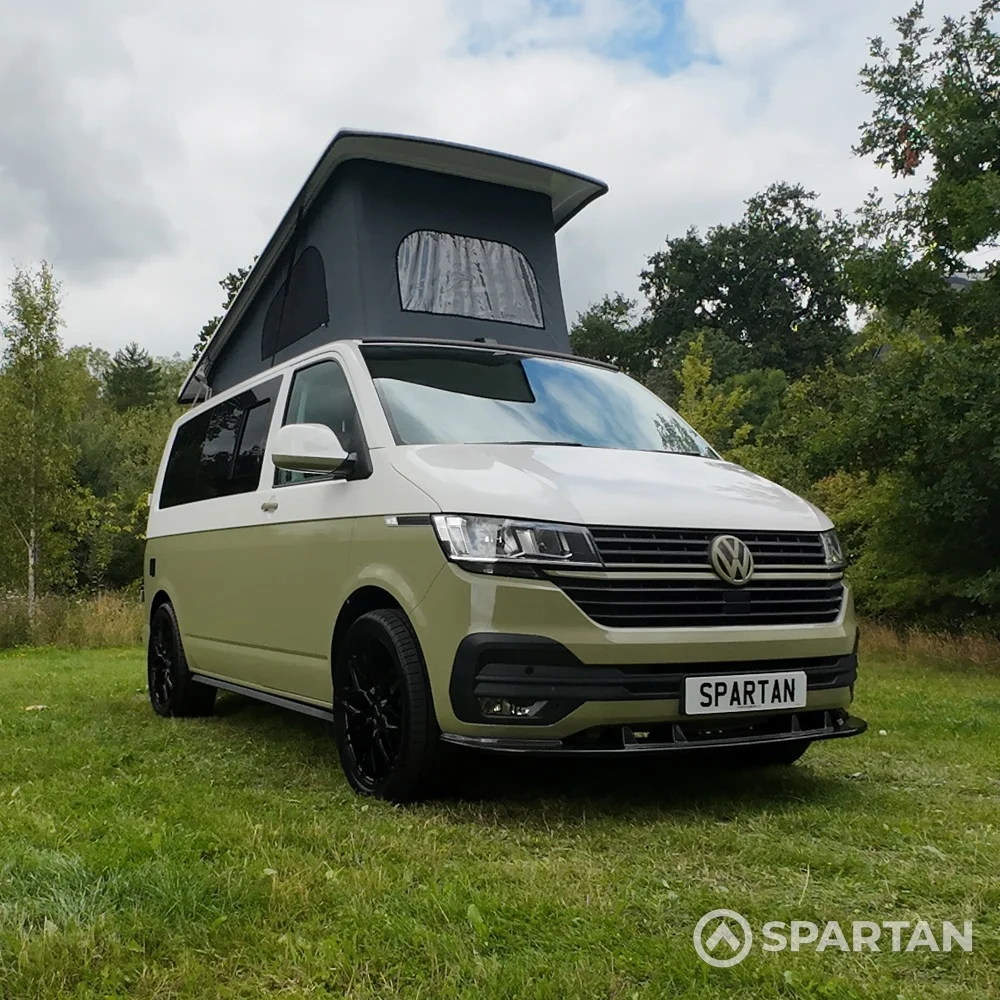 VW T6.1 campervan front driver quarter with pop-top roof up in military green and candy white