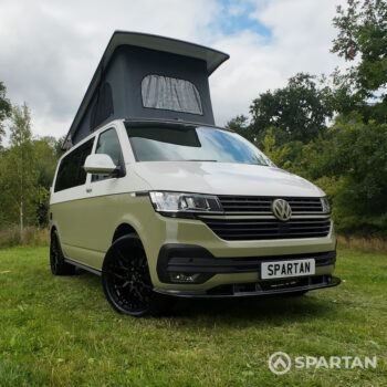 VW T6.1 campervan front driver quarter with pop-top roof up in military green and candy white