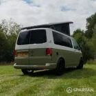 Rear driver quarter of VW T6.1 Highline SWB campervan with roof raised, Military Green and Candy White