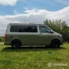 Driver side view of VW T6.1 Highline SWB campervan with pop-top down, Military Green and Candy White