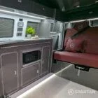 Close-up of VW T6.1 Business Pack LWB campervan kitchen showing integrated hob and white splashback
