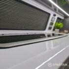Integrated sink and hob in VW T6.1 Business Pack LWB campervan kitchen with white finishes