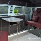 Interior kitchen view of VW T6.1 Business Pack LWB campervan with slate grey cabinets, white detail, and winter flooring