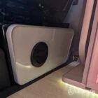 VW T6.1 Highline SWB campervan in white & military green, interior diesel night heater view, champagne oak flooring, latte and winchester oak kitchen, toffee upholstery
