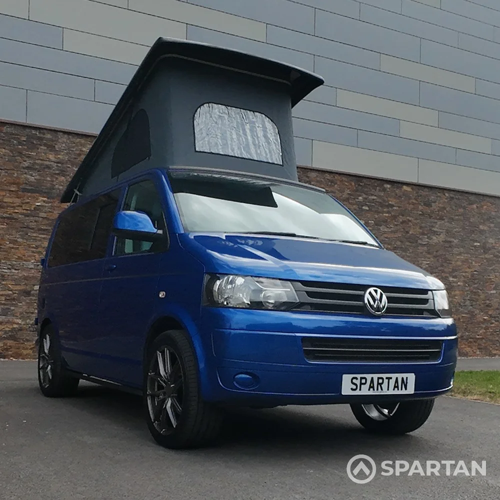 Front Driver Quarter Poptop Up - VW T5.1 SWB Ravenna Blue campervan with Blizzard flooring, light grey and Indigo Blue interior, two tone blue upholstery