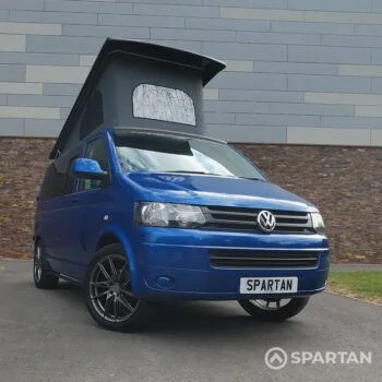Front Driver Quarter Poptop Up - VW T5.1 SWB Ravenna Blue campervan with Blizzard flooring, light grey and Indigo Blue interior, two tone blue upholstery