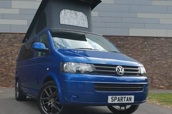 Front Driver Quarter Poptop Up - VW T5.1 SWB Ravenna Blue campervan with Blizzard flooring, light grey and Indigo Blue interior, two tone blue upholstery