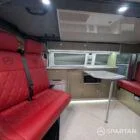VW T6 LWB Deep Black campervan kitchen with olive green cabinetry, latte accents, and winter flooring