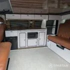 Interior kitchen view VW T6.1 Candy White & Copper Bronze campervan with Winter flooring, high gloss cabinetry and Nolche Marino worktop