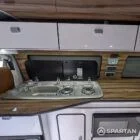 VW T6.1 Candy White & Copper Bronze campervan interior sink and hob close up with Nolche Marino worktop