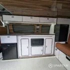 Interior kitchen view VW T6.1 Candy White & Copper Bronze campervan with Winter flooring, high gloss cabinetry and Nolche Marino worktop