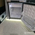 Interior kitchen view VW T6.1 Candy White & Squirrel Grey campervan with Winter flooring, Duck Egg Blue and high gloss white cabinetry