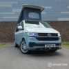 VW T6.1 SWB Squirrel Grey and Candy White campervan front driver quarter poptop up by Spartan Campers