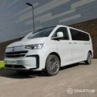 Volkswagen T7 Camper passenger-side front quarter — premium VW T7 conversion showcasing sleek headlights, colour-matched bumpers, and compact van profile.