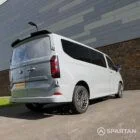 Volkswagen T7 Camper driver-side rear quarter view — Spartan Camper conversion highlighting LED tail lights, rear spoiler, and practical camper setup.