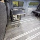 WV T7 day van interior with removable kitchen unit and mobiframe bed on rails