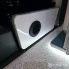 Luxury campervan conversion interior by Spartan with dining seats, compact kitchen, and fitted appliances.