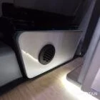 Compact campervan kitchen and seating finished in latte and bardolino oak with champagne oak flooring.