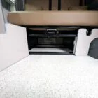 Interior of Spartan Conversion VW T6 featuring winter flooring, latte main units with driftwood detailing, and liquor upholstery seating.