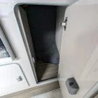 Interior of Spartan Conversion VW T6 featuring winter flooring, latte main units with driftwood detailing, and liquor upholstery seating.