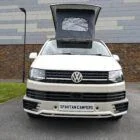 2018 VW T6 Spartan Conversion in two-tone Candy White and Ascot Grey, DSG automatic, parked on display.