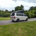 Side view of VW T6 2018 Spartan Conversion LWB campervan, showcasing clean two-tone paint and body styling.