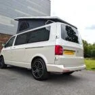 2018 VW T6 Spartan Conversion in two-tone Candy White and Ascot Grey, DSG automatic, parked on display.
