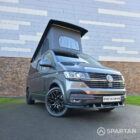 VW T6.1 Transporter in Indium Grey with a Spartan campervan conversion, parked outdoors with clean lines and a practical touring profile.