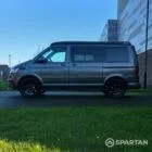 VW T6.1 Transporter in Indium Grey with a Spartan campervan conversion, parked outdoors with clean lines and a practical touring profile.