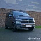 VW T6.1 Transporter in Indium Grey with a Spartan campervan conversion, parked outdoors with clean lines and a practical touring profile.